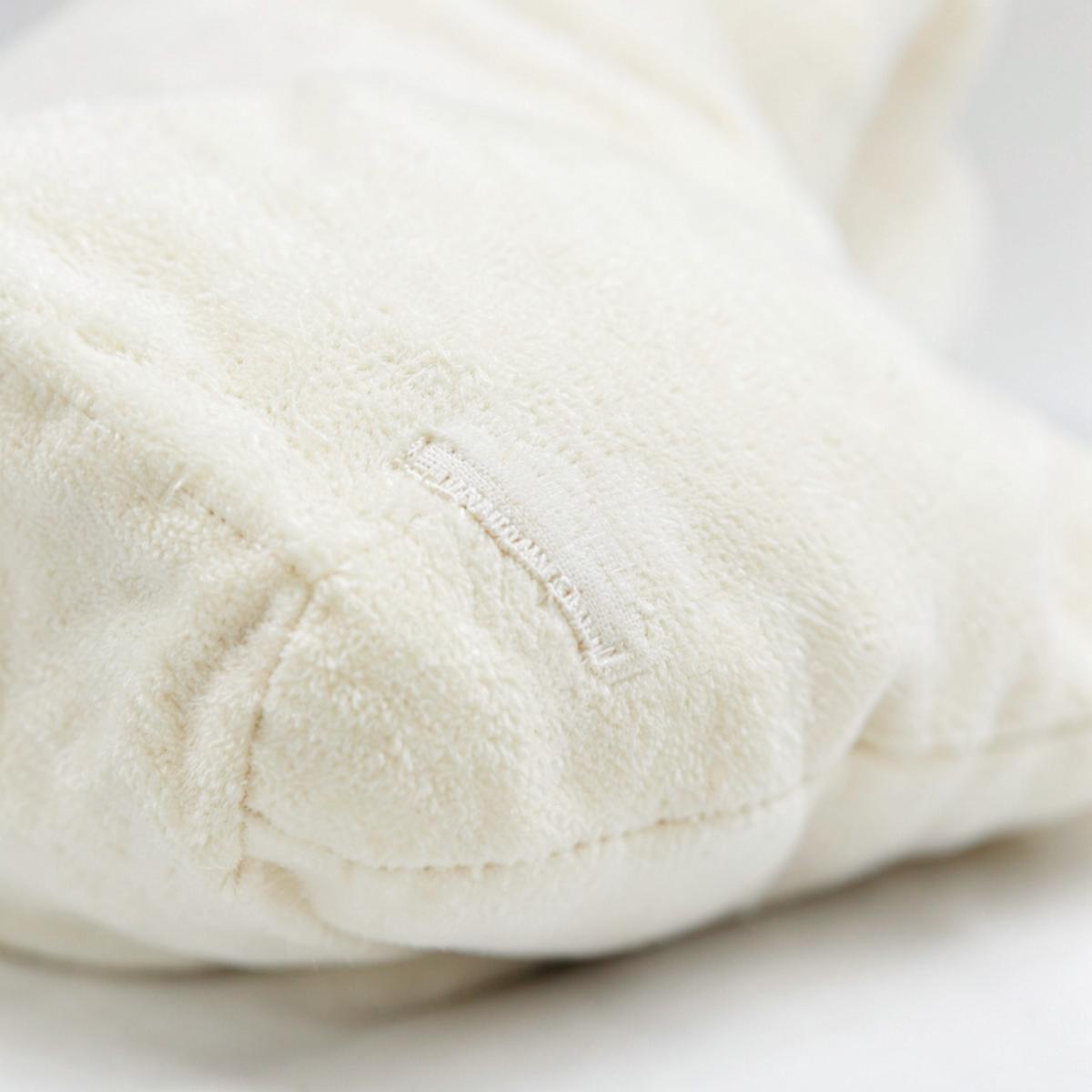 Close-up of the soft cream reverse of a Puff pillow