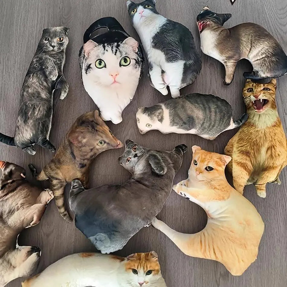 Fifteen custom pet photo pillows in different cat and dog shapes laid out on a wooden floor